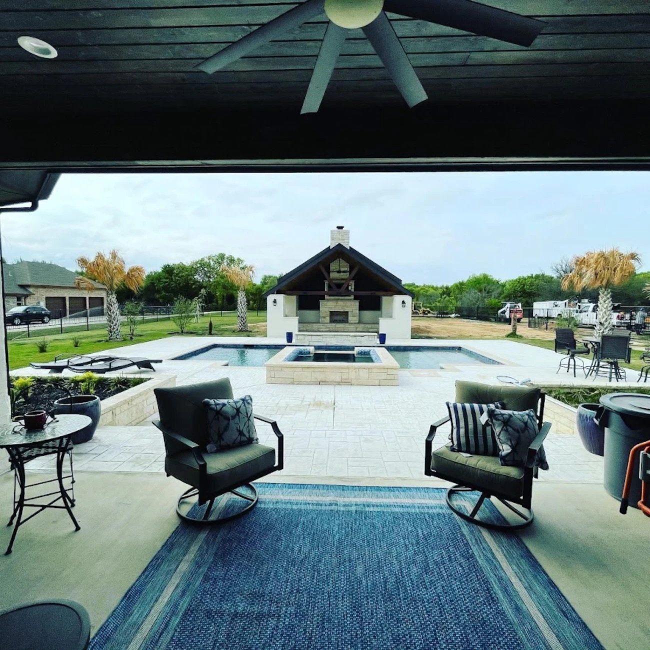 Covered patio overlooking pool and outdoor living area
