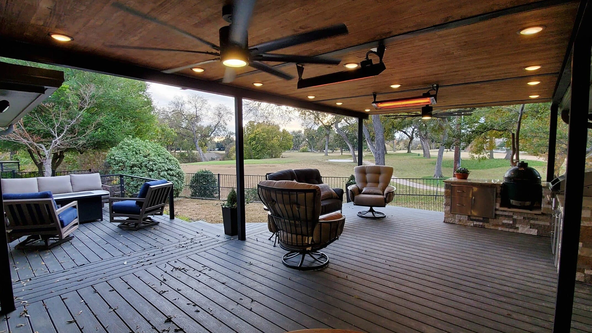 Covered outdoor deck with ceiling fan and seating area